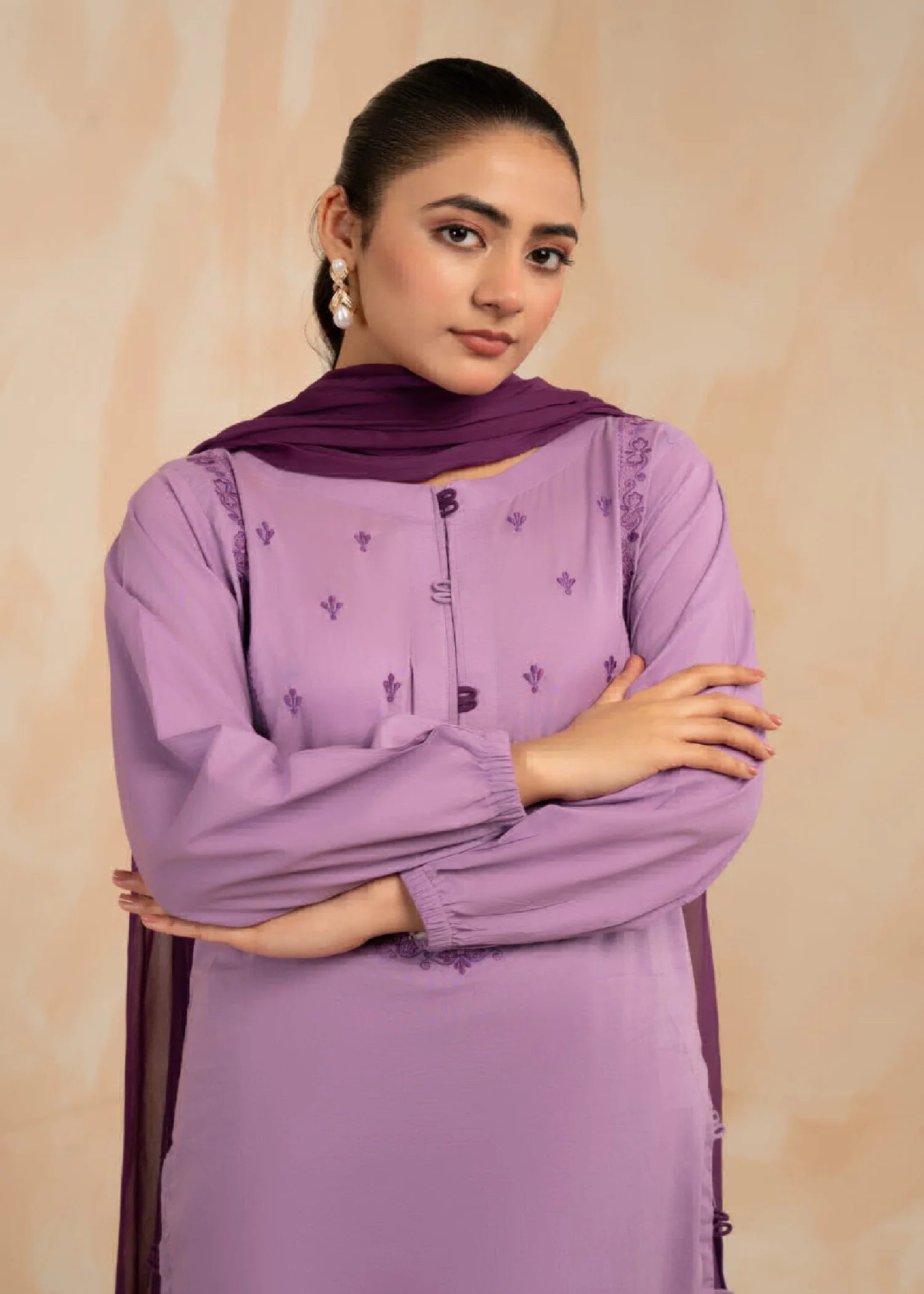 Woman wearing a floor-length pink floral dress with long sleeves